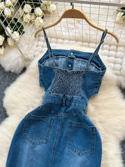 Denim maxi dress with smocked back, button front, chest pockets and frayed hem.