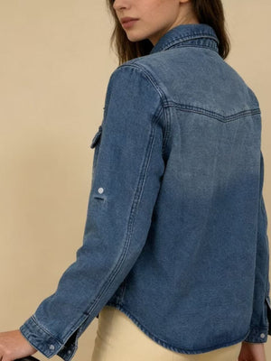 Blue denim overshirt with button cuffs and roll-tab sleeves, classic western yoke detail.
