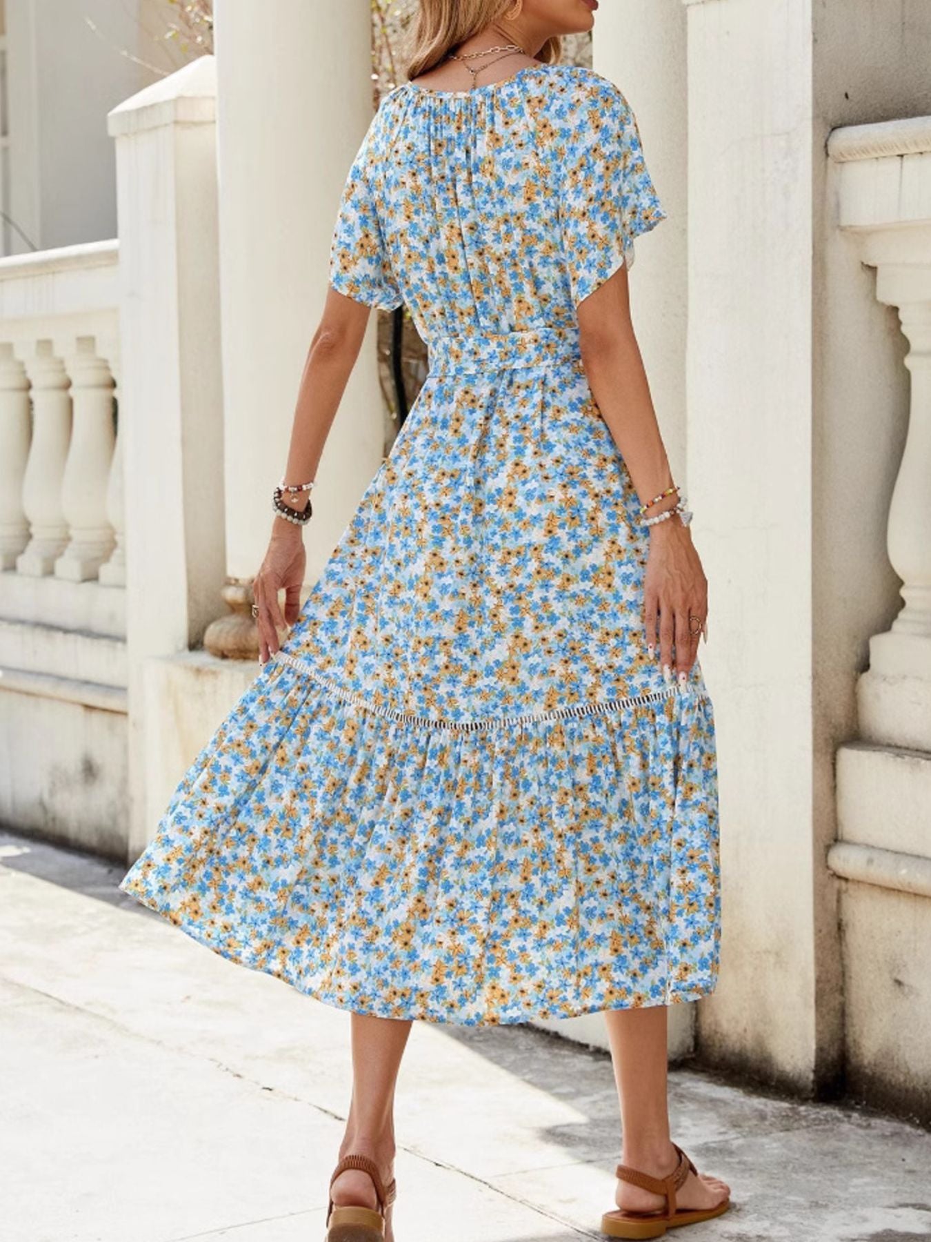 Daisy print midi dress with tie front, short sleeves, and tiered hem.