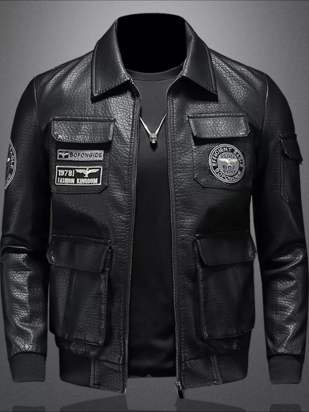 Black leather bomber jacket with multiple patches and cargo pockets.