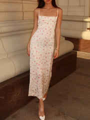 Print midi dress with spaghetti straps, square neckline, and a pink floral pattern on a white background.