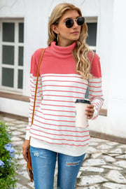 Colorblock stripe turtleneck knit sweater with coral and white horizontal stripes.