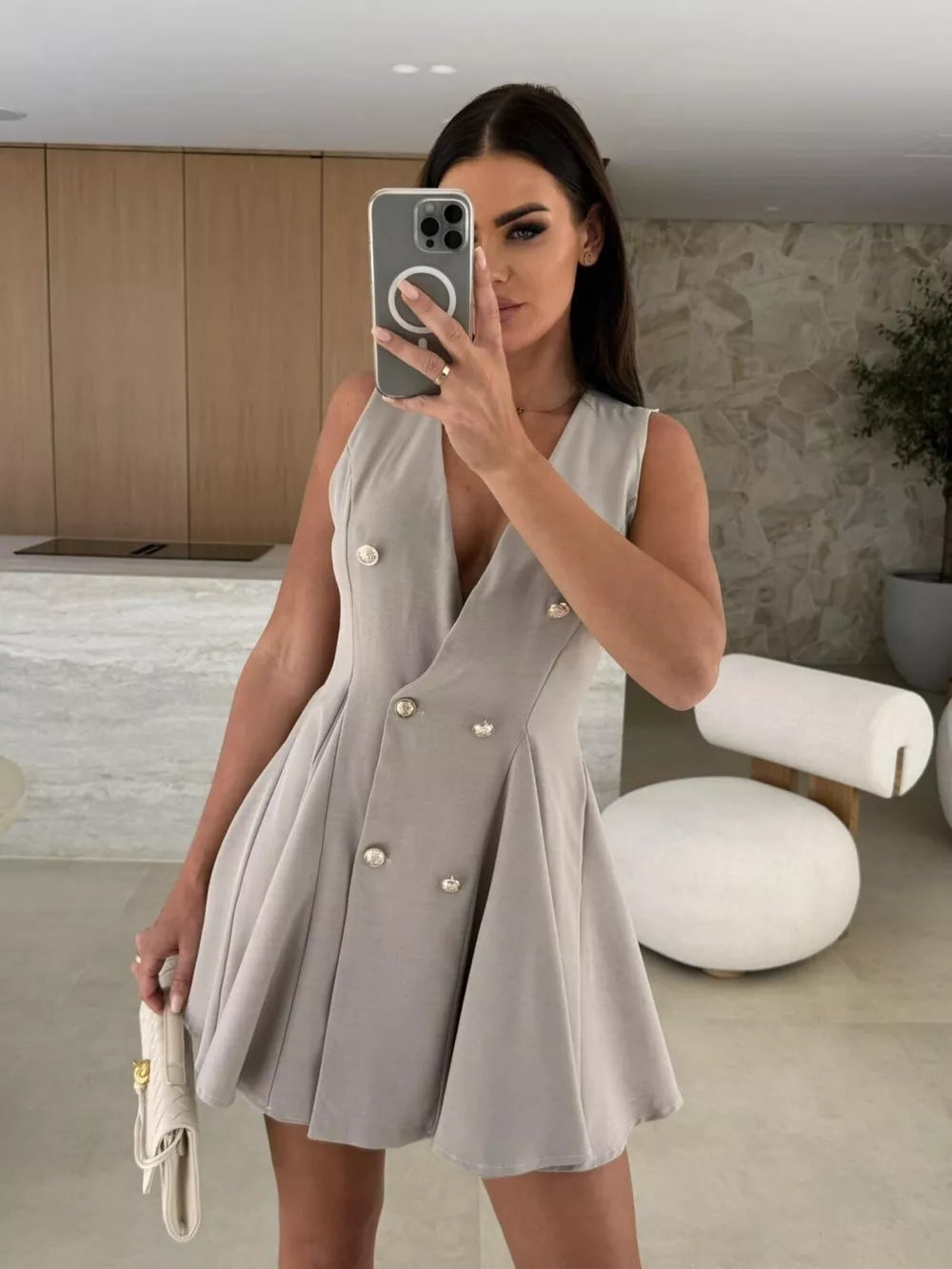 Gray double-breasted mini dress with gold buttons and pleated skirt, V-neck, sleeveless.