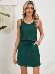Geometric eyelet crossover strap dress in dark green with drawstring waist and pockets