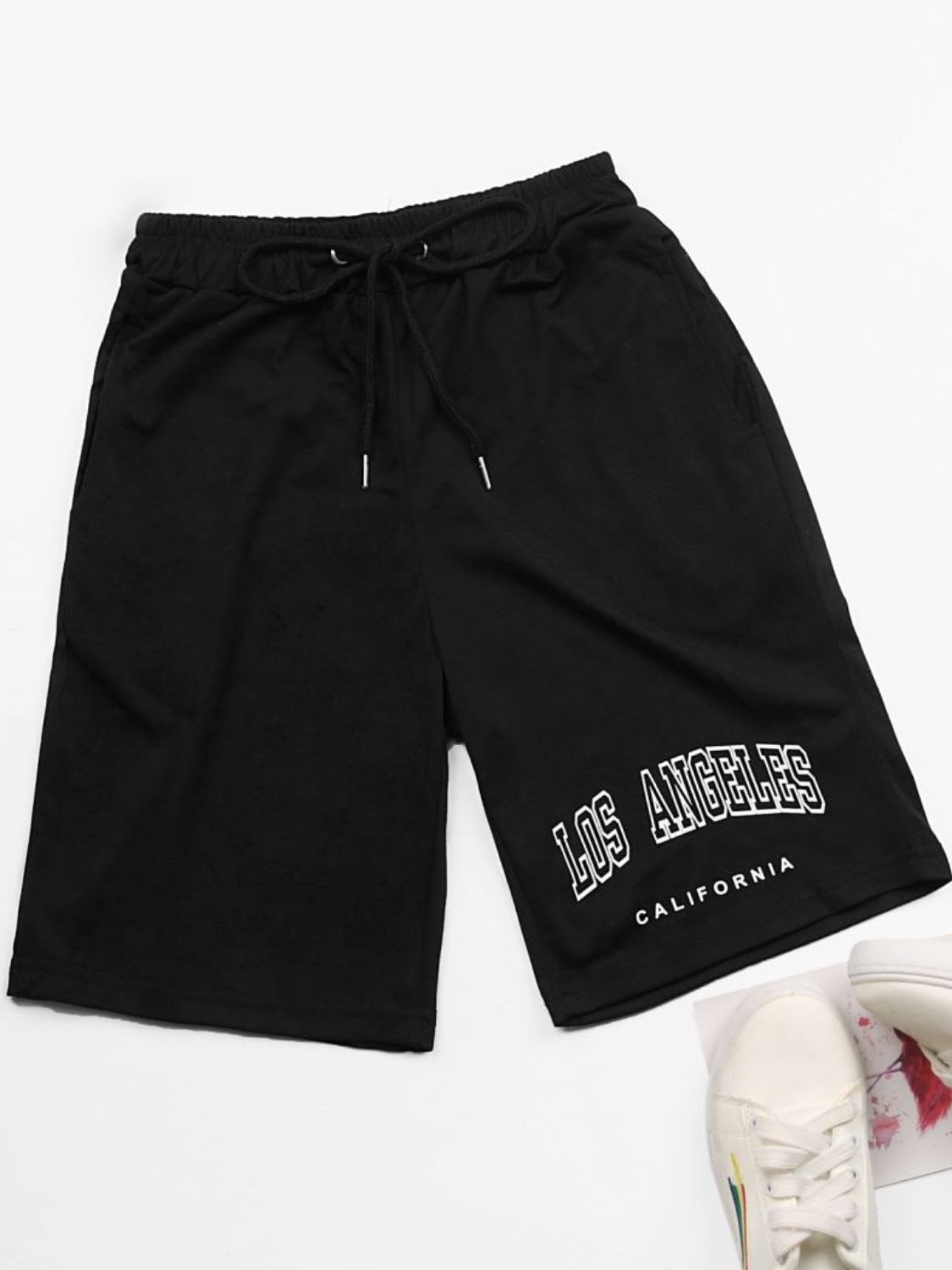 Black jogger shorts with "Los Angeles California" graphic print and drawstring waist.
