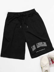 Black jogger shorts with "Los Angeles California" graphic print and drawstring waist.