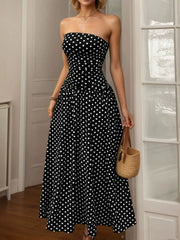 Black polka dot strapless maxi dress with a ruched bodice and full skirt.