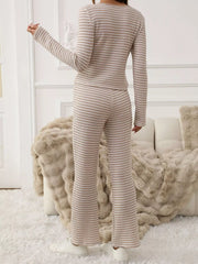 Tied two-piece set in apricot with horizontal stripes, long sleeves, and flared pants.