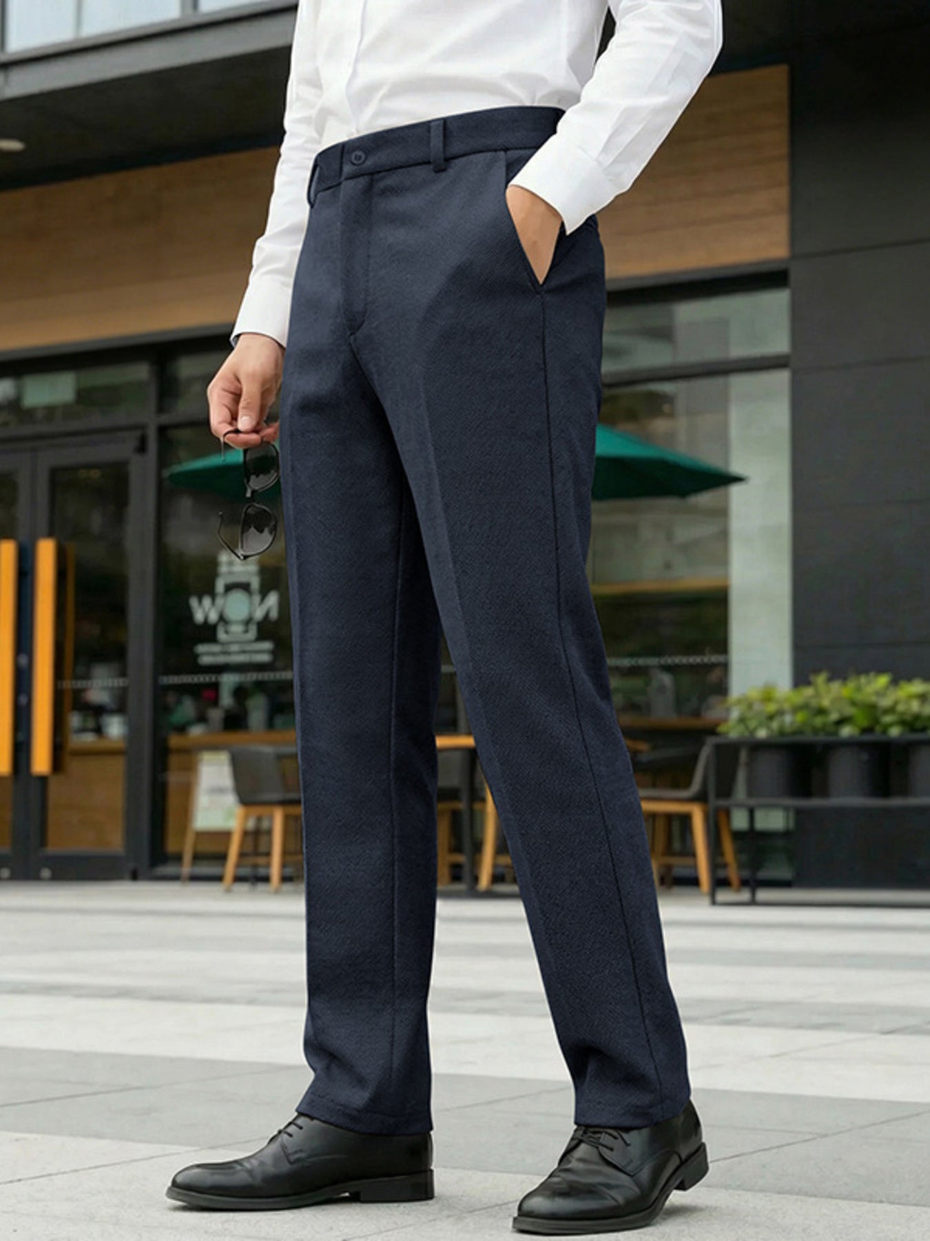Men's navy classic fit dress pants with pockets, styled with a white dress shirt.
