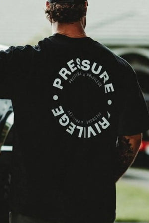 Black graphic t-shirt with circular "PRESSURE PRIVILEGE" text on back