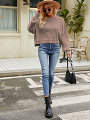 Boxy ribbed knit sweater in taupe with mock neck and dropped shoulders.