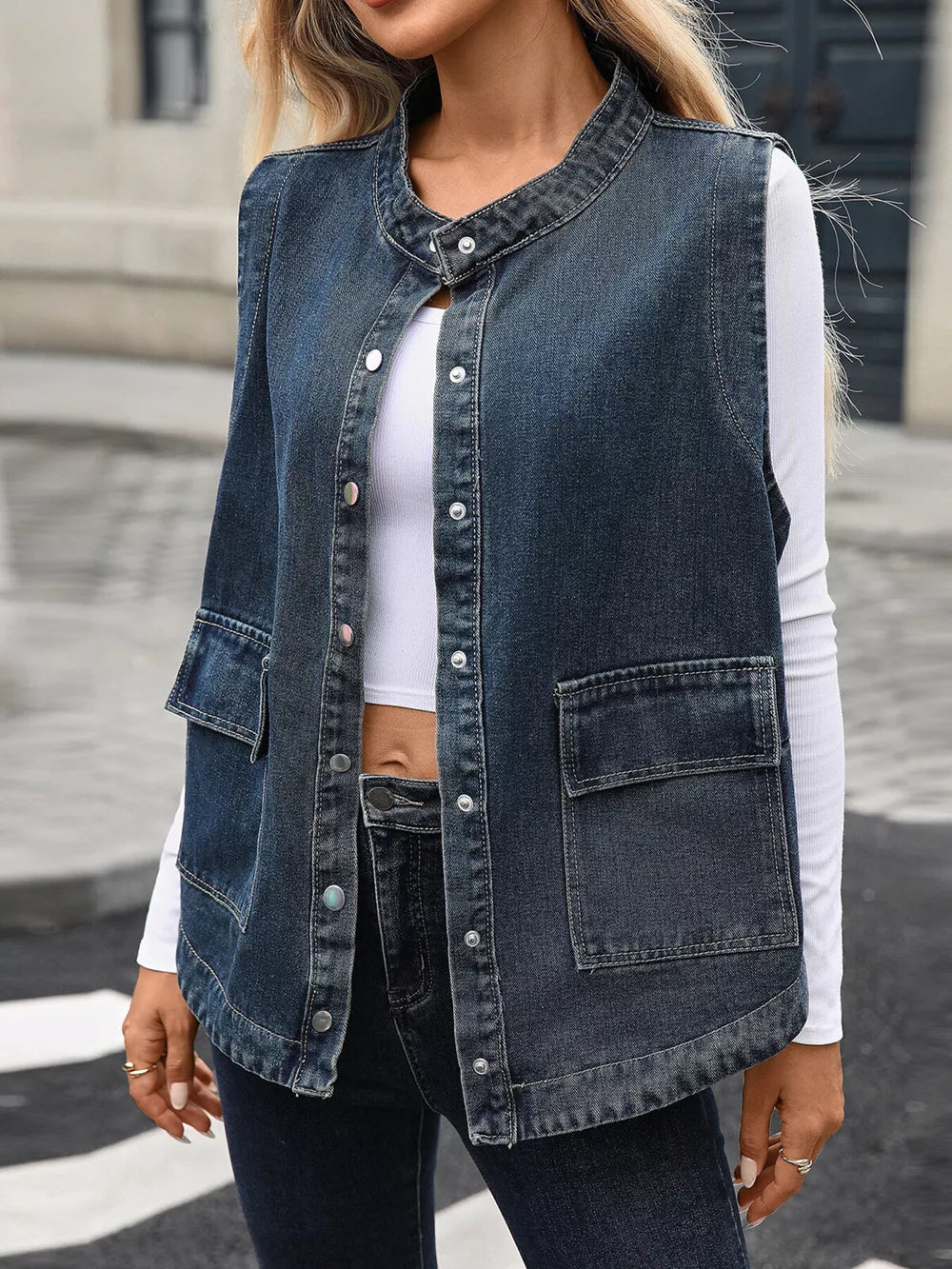 Washed black denim vest with band collar, button front, and two chest pockets.