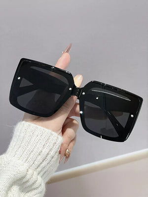 Oversized square black gradient sunglasses with silver stud details.
