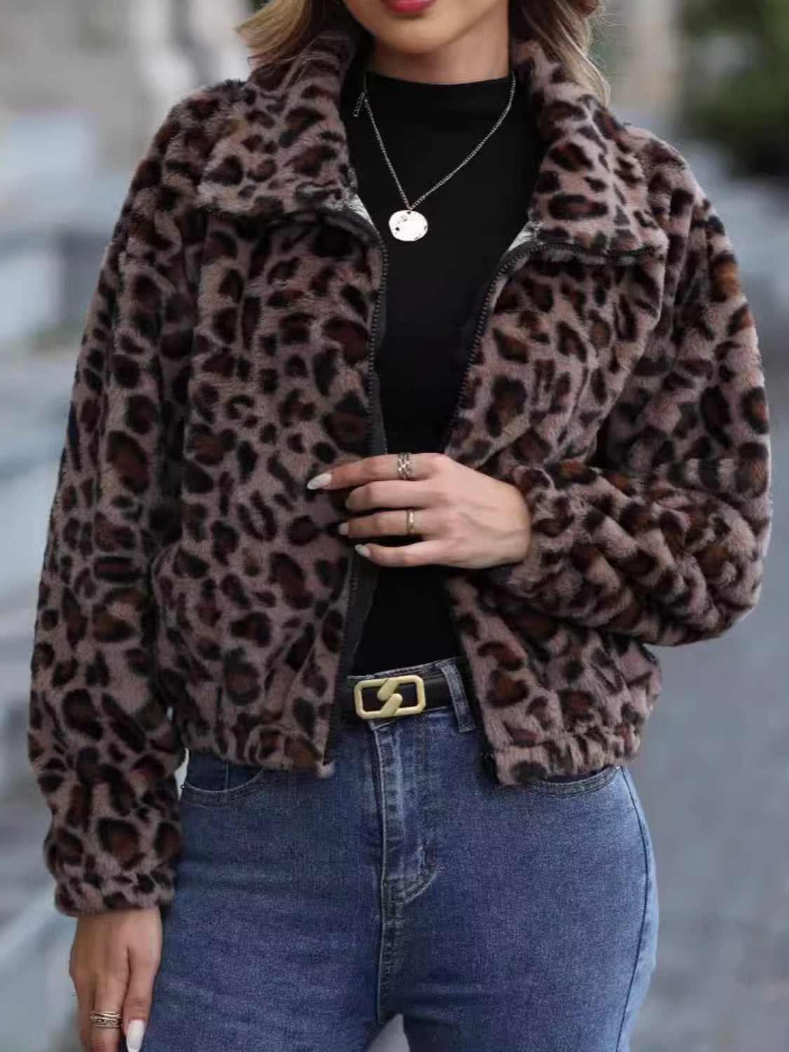 Leopard print faux fur zip-up jacket with a collar and long sleeves.