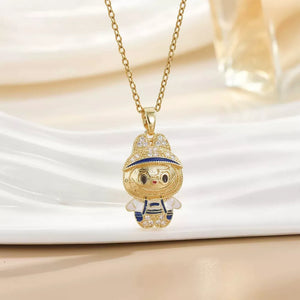 Gold-plated character pendant necklace with blue and white enamel details and crystal accents.