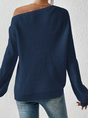 Navy blue asymmetrical knit sweater with off-shoulder neckline and long sleeves.