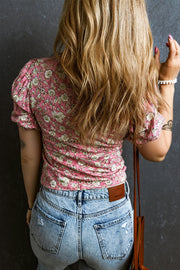 Floral ruched bodice puff sleeve top with short sleeves and a floral print.