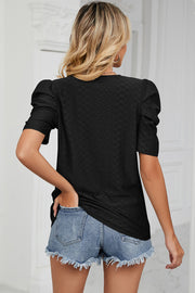 Black perforated puff sleeve top with textured pattern and short sleeves.