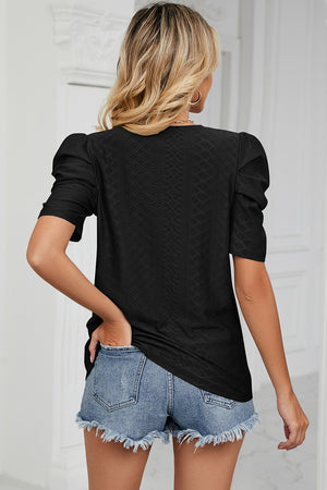 Black perforated puff sleeve top with textured pattern and short sleeves.