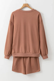 Taupe loungewear set with crewneck sweatshirt and shorts.