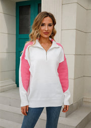 Colorblock zip-neck knit pullover sweater in white with hot pink sleeves.
