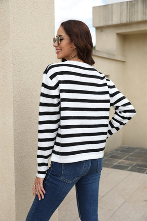 Black and white striped crewneck cardigan with long sleeves.
