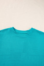 Turquoise textured co-ord set with geometric pattern and crew neck.
