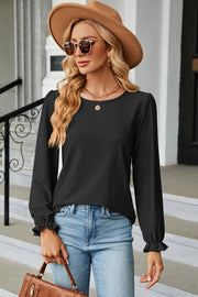 Black textured puff sleeve blouse with ruffled cuffs