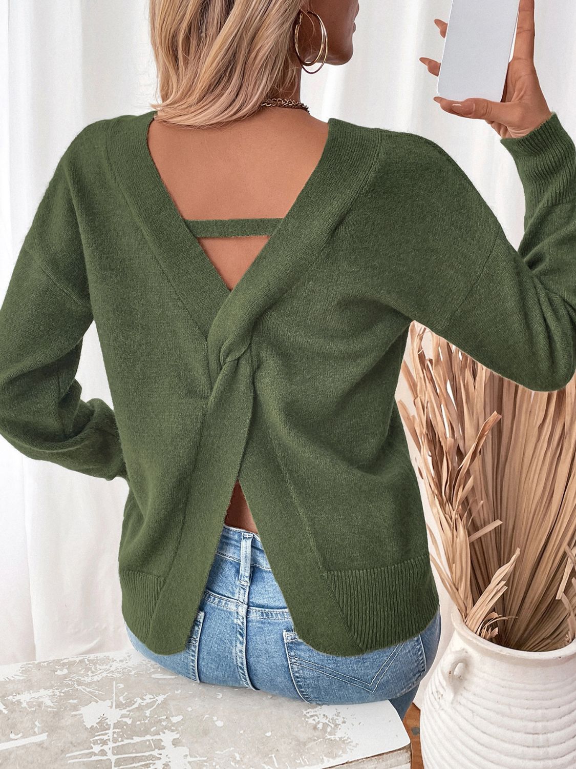 Army green acrylic knit sweater with V-neck and twisted back detail.
