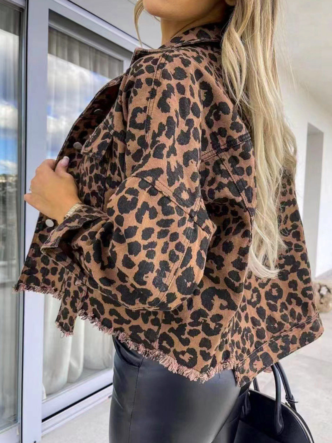 Leopard print denim shacket with raw hem detail and button front.
