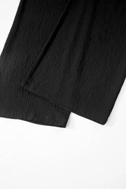 Black textured maternity wide-leg pants with crossed waist detail