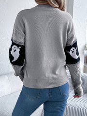 Gray knit crewneck sweater with ghost motif on sleeves, cable knit details.