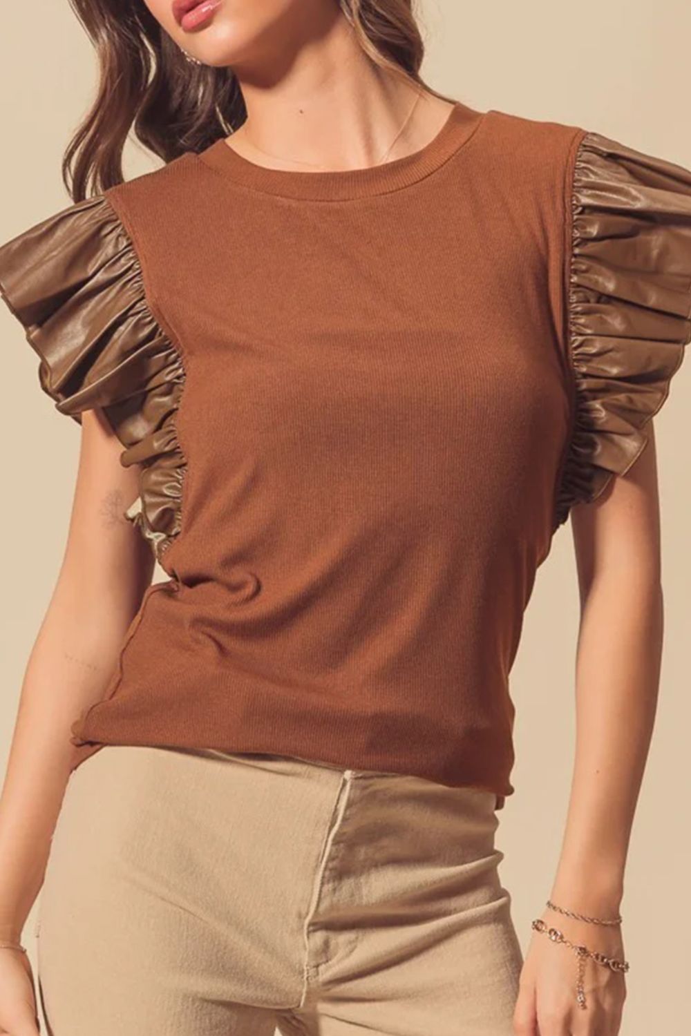 Brown ribbed knit top with ruffled faux leather short sleeves