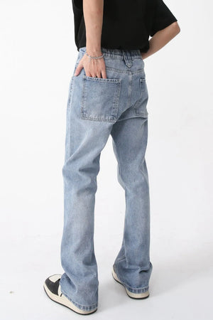 Medium wash wide-leg denim jeans with carpenter pocket detail