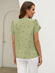 Matcha green blouse with black heart print, puff sleeves, and V-neck.