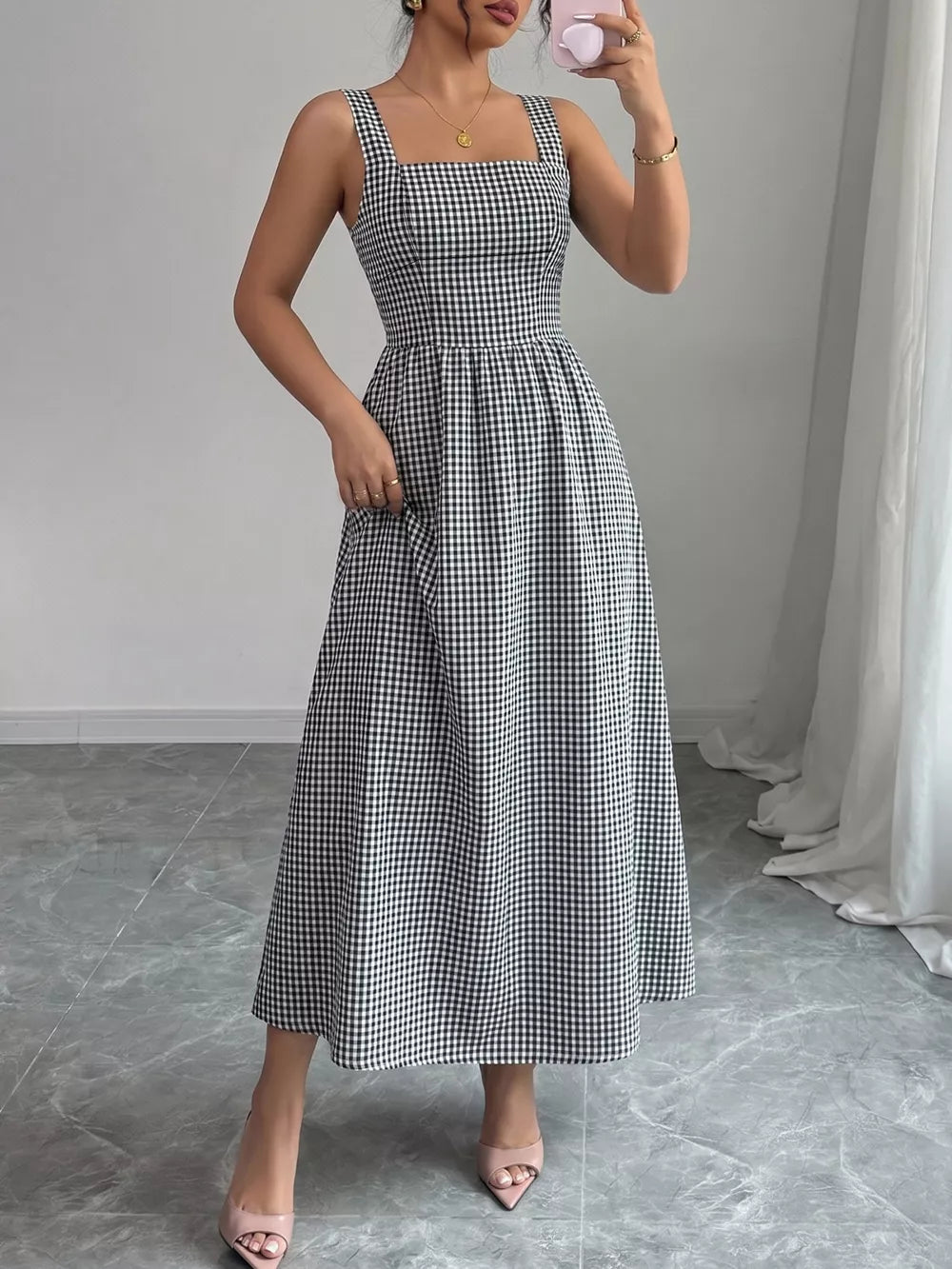 Black and white gingham midi dress with square neckline and a-line skirt.