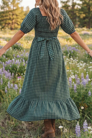Plaid maxi dress with ruffled hem, square neckline, puff sleeves, and a tie waist.