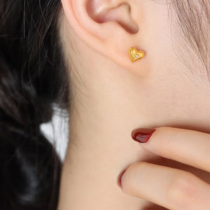 Gold heart stud earrings with a diamond accent, perfect for daily wear.