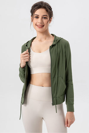 Matcha green zip-up hoodie with drawstrings and pockets, worn open over a sports bra.
