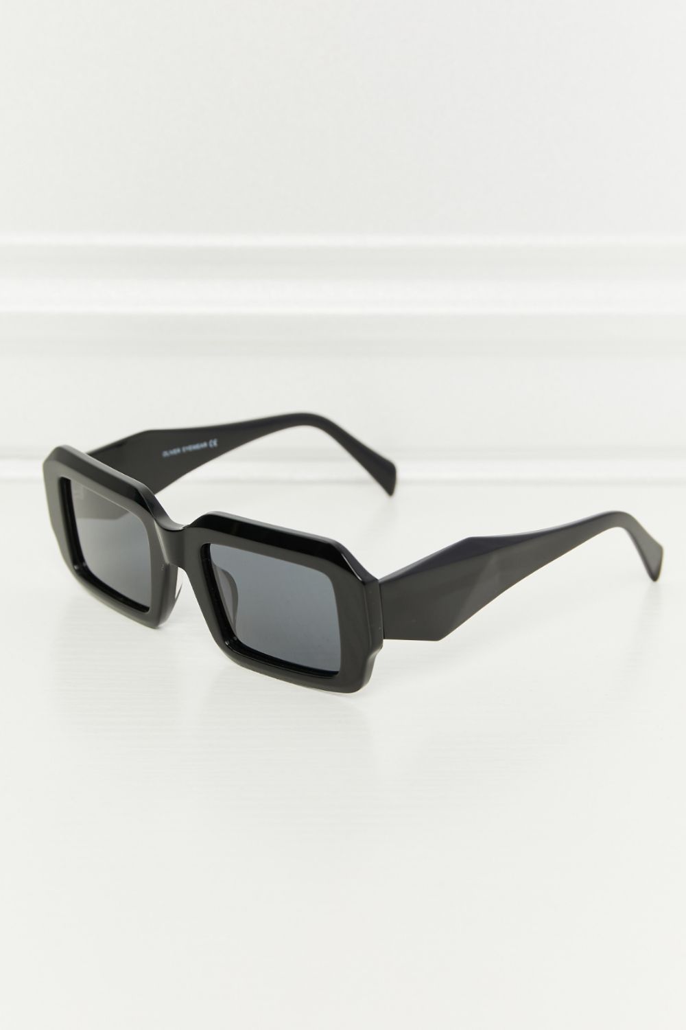 Black geometric frame polarized sunglasses with acetate material.
