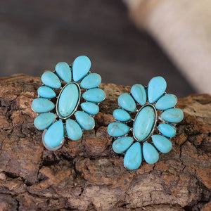 Turquoise petal stud earrings with silver setting and teardrop stones.