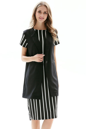 Black tailored sleeveless vest with single button closure over a striped dress.