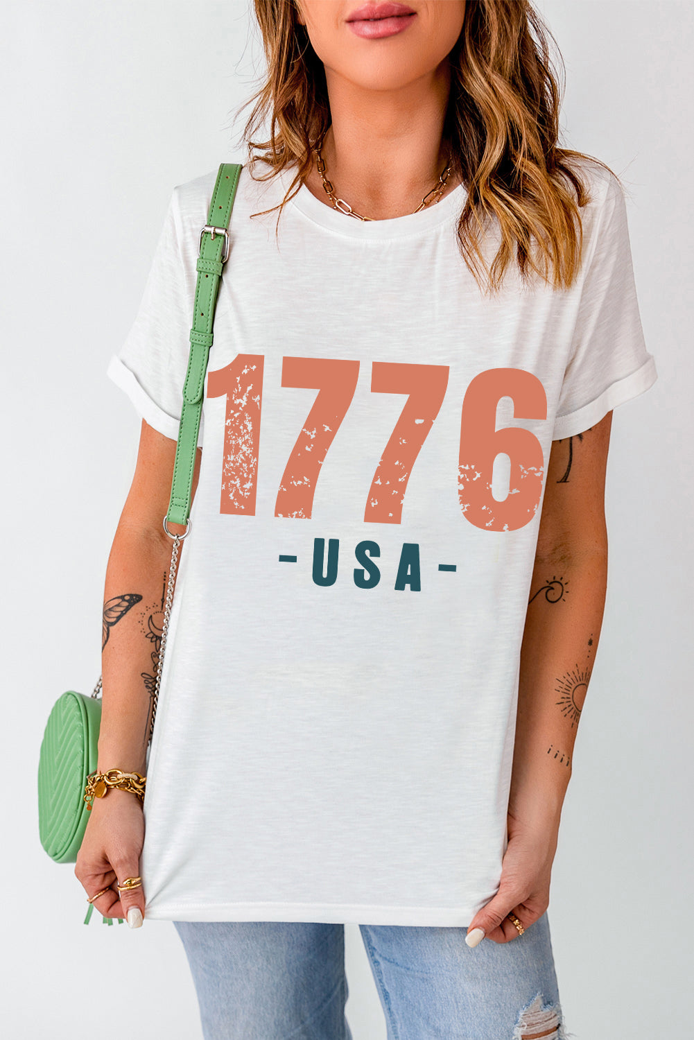 White t-shirt with distressed 1776 USA graphic, crew neck, short sleeves.