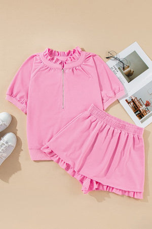 Pink cotton co-ord set with ruffled neckline zip-up top and ruffled hem shorts