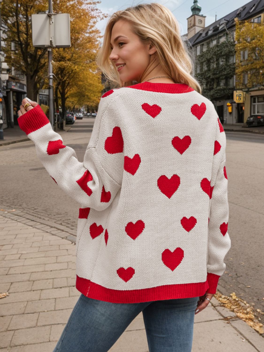 Cream acrylic cardigan with red heart intarsia pattern and red trim