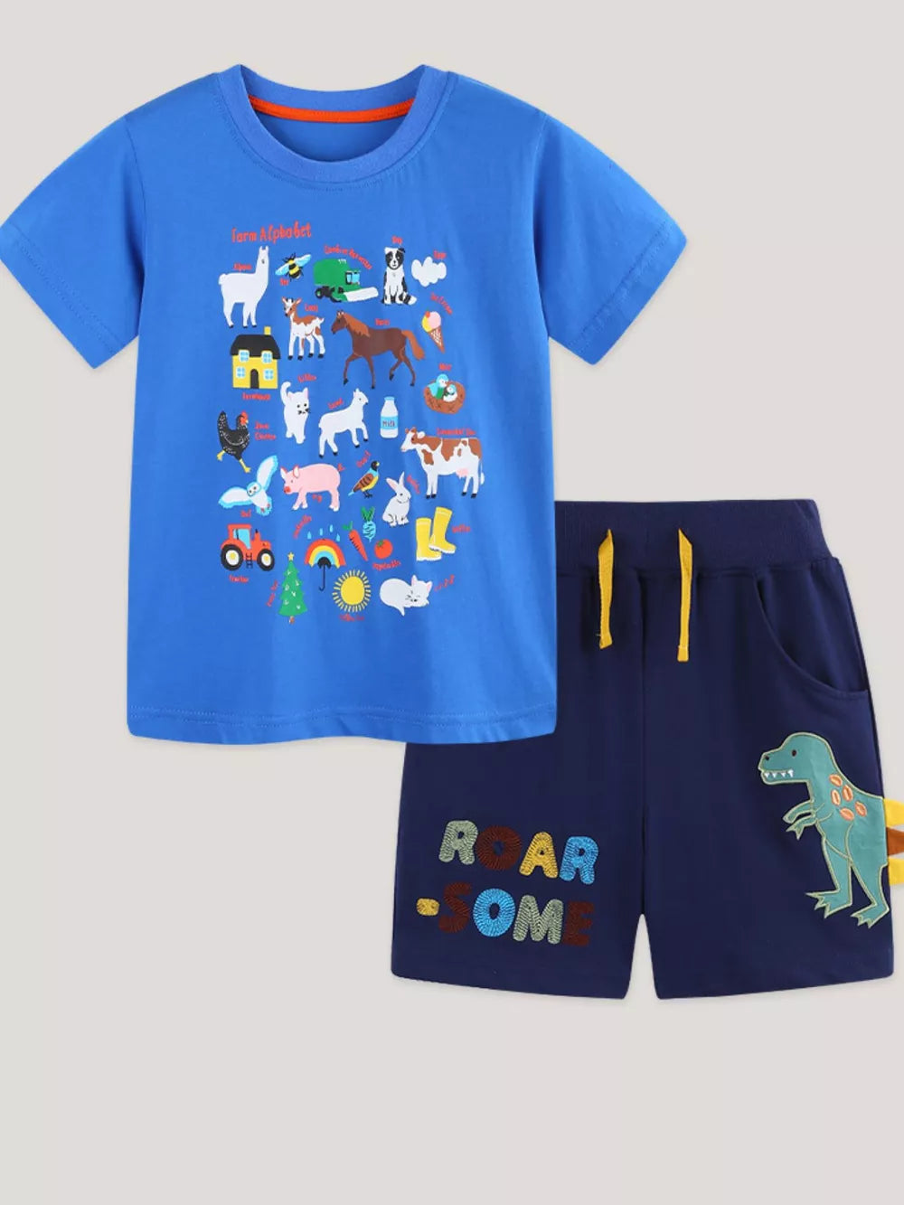 Blue cotton alphabet farm tee and navy adventure shorts with dinosaur applique.