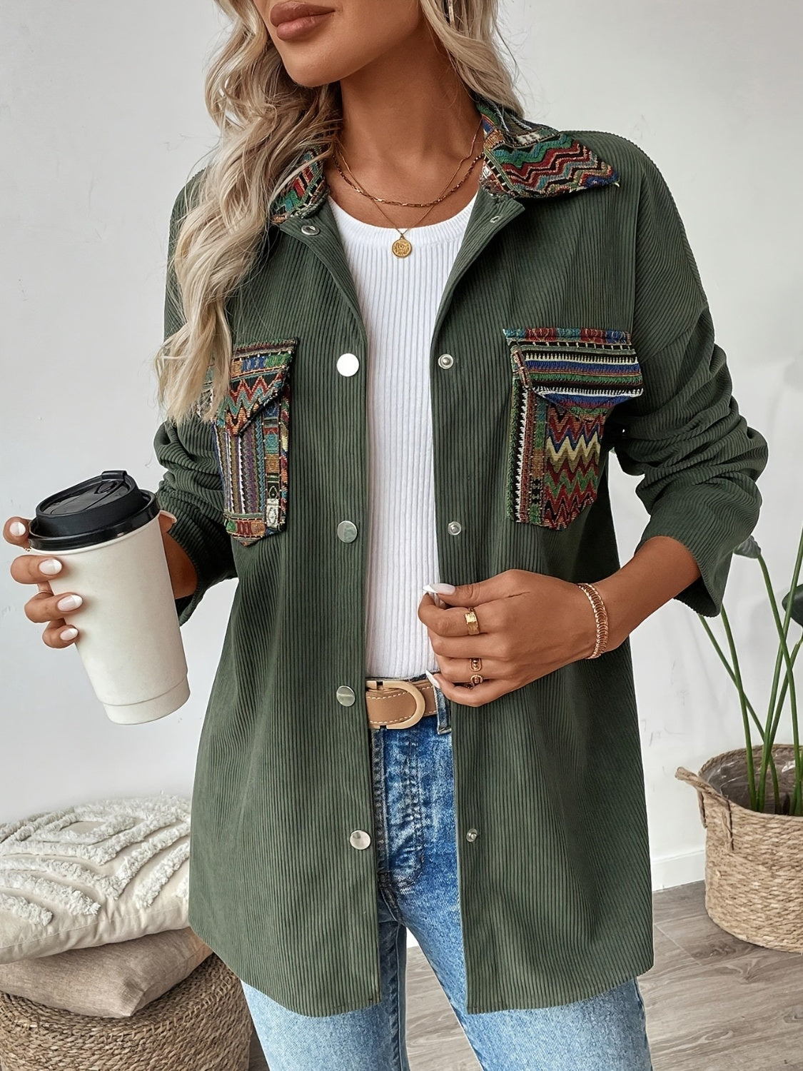 Army green corduroy overshirt with embroidered statement pockets and collar detail.