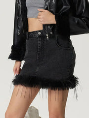 Black denim mini skirt with feather trim and button closure.