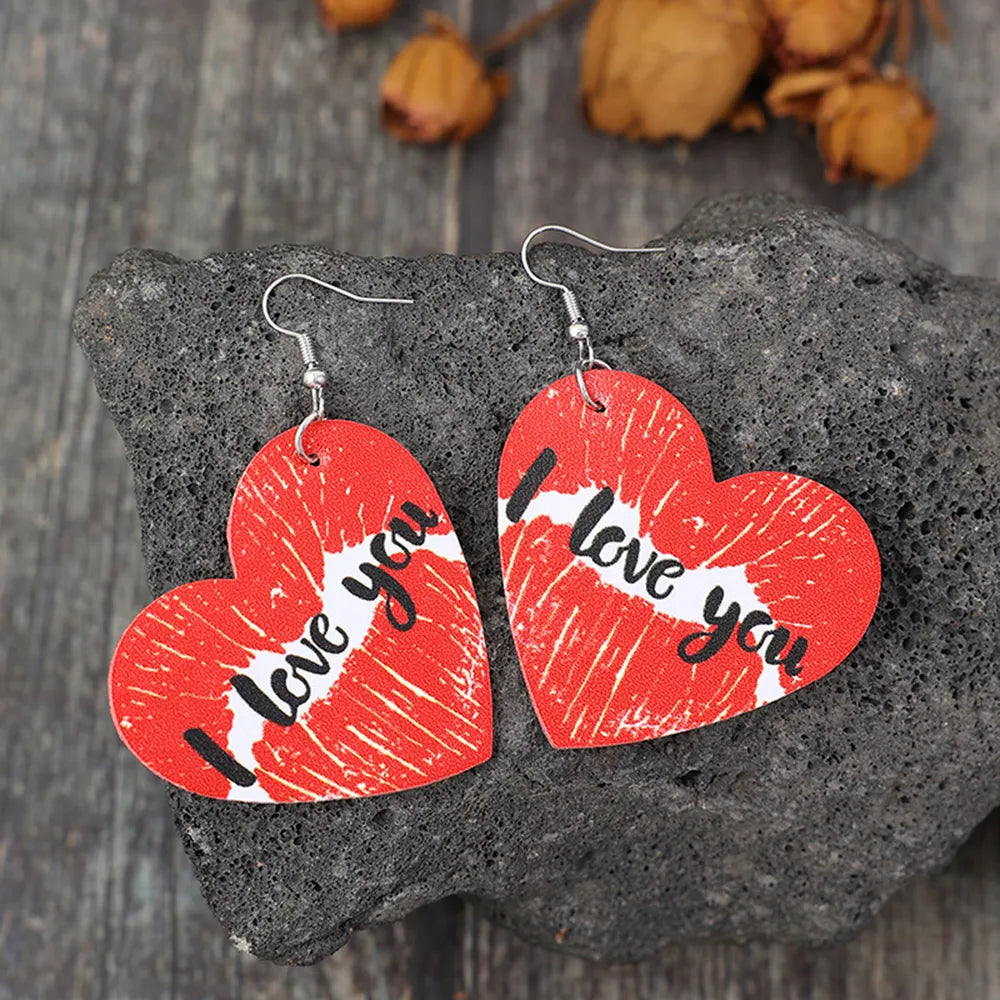 Red heart drop earrings with kiss print and "I love you" text.