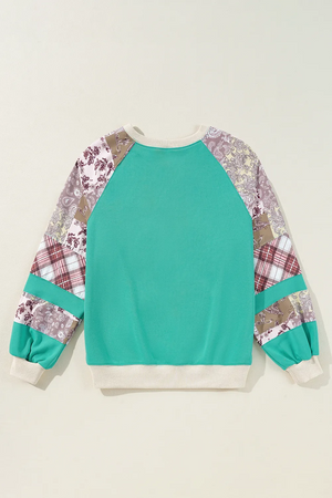 Turquoise patchwork raglan sleeve sweatshirt with paisley and plaid details.